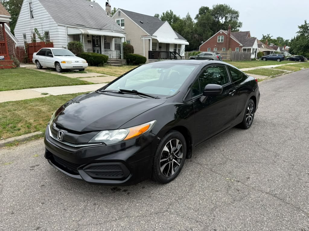 Black Honda Civic coupe parked on a residential street.