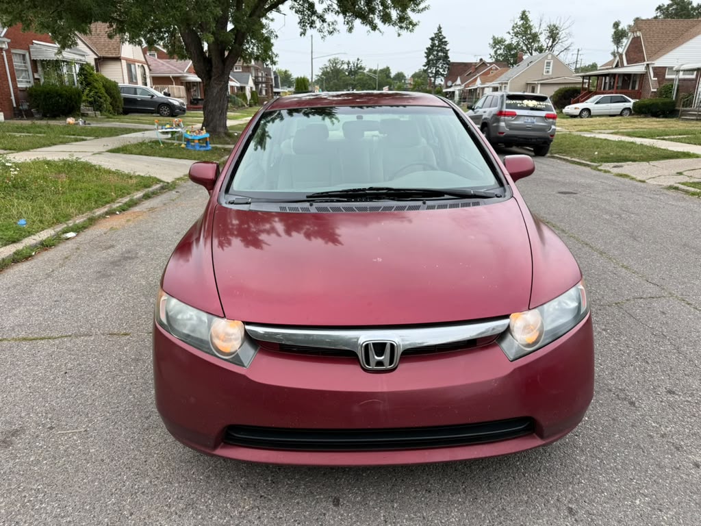 Red Honda Civic sedan photographed head-on.